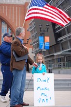 Attendees holding signs at a Tea Party rally in Dallas, TX (one of the first in the United States on Feb. 26 2009). Man in the picture is James Dickey, future leader of the Texas Republican party.