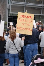Attendees holding signs at a Tea Party rally in Dallas, TX (one of the first in the United States on Feb. 26 2009)