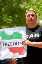 Iranians in Texas taking part in a Freedom for Iran / Green Revolution rally at Dallas City Hall plaza in downtown Dallas, TX; protest signs ca. June 2009