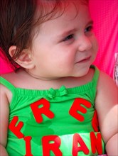 Iranians in Texas taking part in a Freedom for Iran / Green Revolution rally at Dallas City Hall plaza in downtown Dallas, TX; young child wearing a Free Iran top ca. June 2009