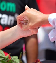 Iranians in Texas taking part in a Freedom for Iran / Green Revolution rally, two protestors hold hands, at Dallas City Hall plaza in downtown Dallas, TX ca. June 2009