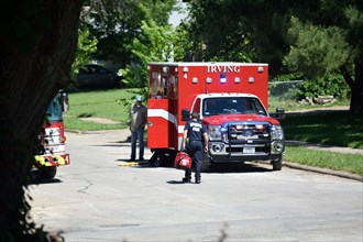 First responders; firemen and paramedics, help trapped construction worker trapped in a trench; Ambulance arrives to the scene of the emergency Irving, TX USA