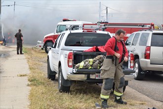 Firefighters on the scene of a truck fire, this fireman prepares to help, in Guymon, Oklahoma
