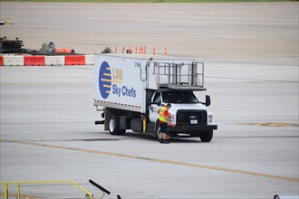 Dallas-Ft. Worth Airport: An LSG Sky Chefs worker standing outside his truck on the international terminal's tarmac of DFW Airport