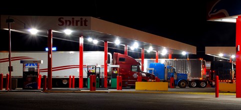 Truckers filling up with gas at the Sapp Brothers truck stop at night, east of Cheyenne Wyoming  on Interstate 80