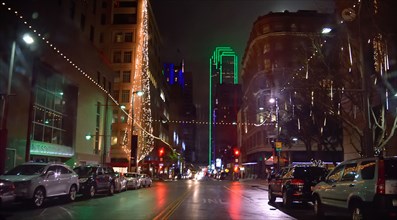 Office buildings and street scene in downtown Dallas at night during the Christmas season
