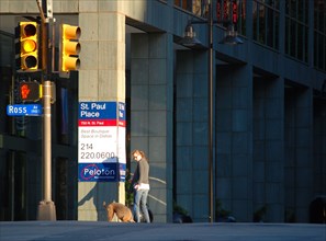 A woman walks her dog in downtown Dallas, TX