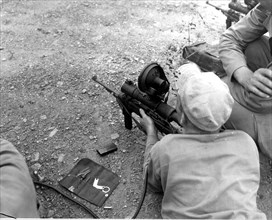 Marine firing a carbine, 1953