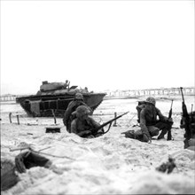 Marines moving along the beach, 1944