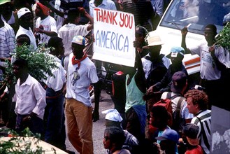 Haitians  hold up a 'Thank You America'