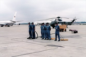 An aircraft maintenance crew stands by as President Jimmy Carter returns from his European visit.