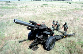Artillerymen prepare to load an M114A1 155 mm howitzer during a live