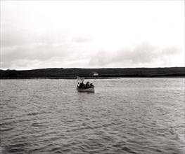Men in Boat in Village Cove