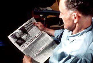 Phillip Manhard reads a Stars and Stripes newspaper