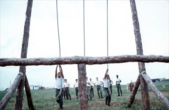 US Army recruits encounter a rope swing on the obstacle course.