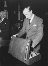 1930s Man looking through his briefcase