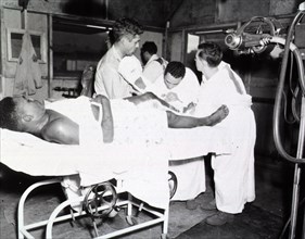 A leg cast being removed from a patient in the 251st Station Hospital
