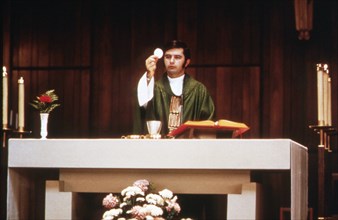 A Priest Is Shown Distributing Communion