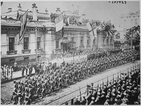 Allied troops march in front of the Allies Headquarters Building
