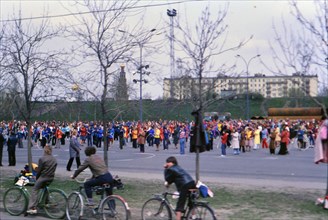 Bicyclists watching a parade of people in Moscow ca. May 1978