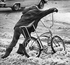 Boy Pushing Bike Across Slushy Street November 1966