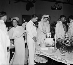Bride cutting cake at wedding reception