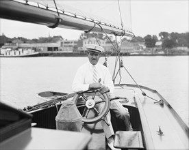 Captain at the wheel of a sailboat on the Potomoc River