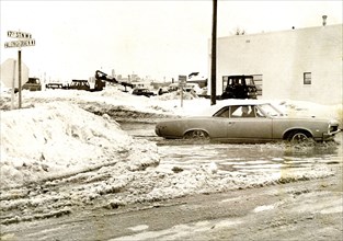 Car at Flooded Intersection with Much Snow