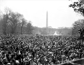 Crowd gathered on the mall; Washington Monument in background