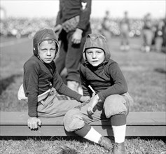 Early 1900s pee wee football players / young children playing football