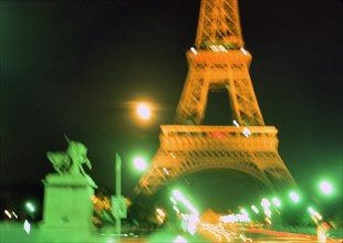Early 1970s Blurred lights of Paris France at night at the Eifel Tower ca. 1974