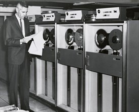 Edward Stone in front of an IBM Computer