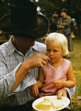 Farmer feeding his daughter
