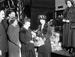 First Lady Grace Coolidge handing out Christmas baskets ca. 1923 or 1924