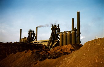 Iron ore piles and blast furnaces