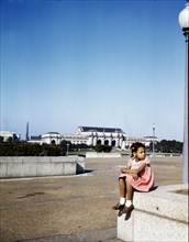Little girl in a park with Union Station in the background