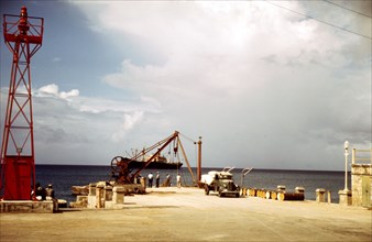 Loading cargo on a freighter in the harbor of Frederiksted