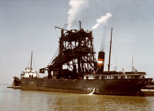 Loading coal into a freighter at one of the Pennsylvania Railroad docks