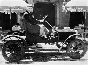 Man driving vintage automobile