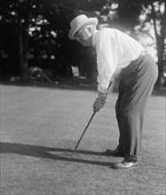 Man playing golf in 1916