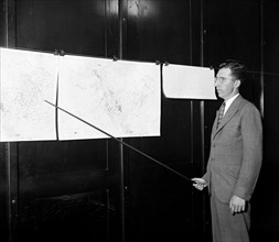 Man pointing to weather maps