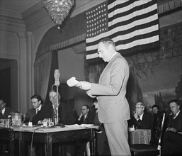 Man reading from a piece of paper at a patriotic event