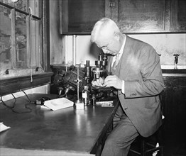 Man using microscope in laboratory