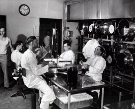 Men in laboratory with test tubes ca. 1944