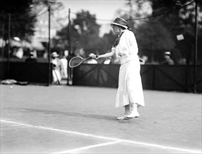 Miss Eva Baker playing tennis at a tournament in 1912