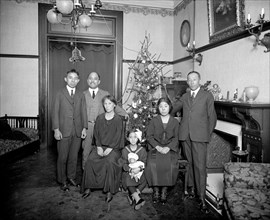 Parents with children around a Christmas tree