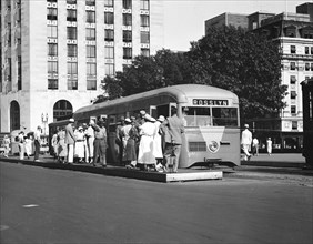 Passengers waiting to board a streamlined street car