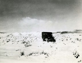 Person Inside Car on Snowy Field ca 1938
