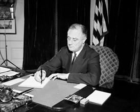 President Franklin Roosevelt sitting at a desk