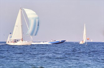 Sailboats and speedboat off the coast of Florida